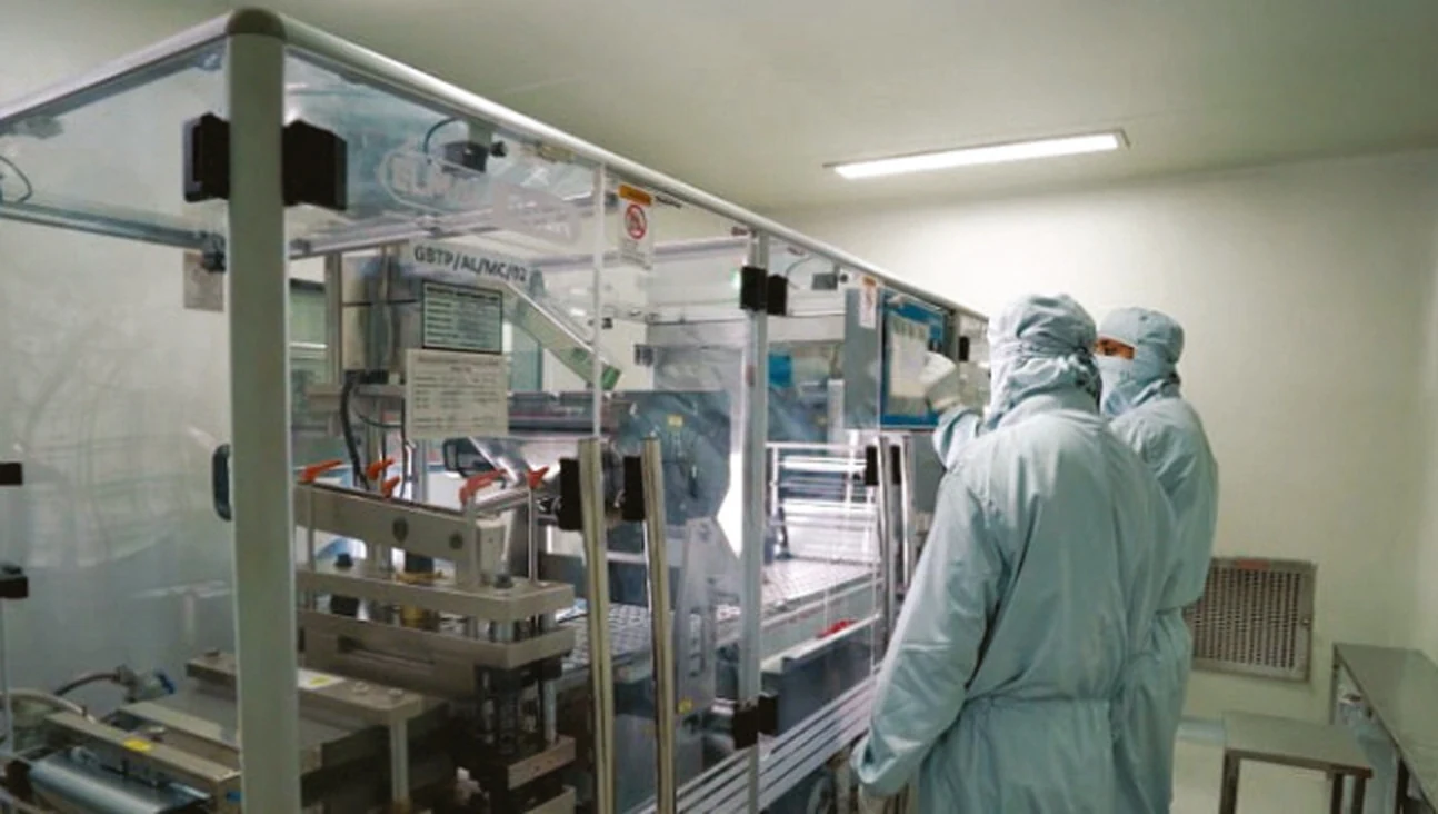 Quality team weighing and verifying batch samples at a calibrated dispensing station