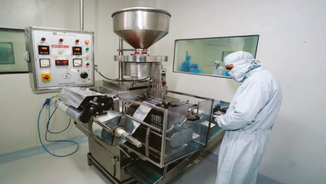 Aseptic filling suite with laminar airflow enclosures and operators in full cleanroom gowning